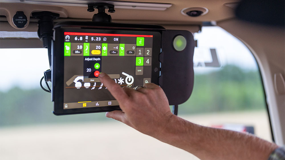 Hand using the control system Väderstad E-Control in the tractor