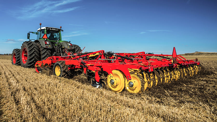 A red and yellow Väderstad combination cultivator in the field 
