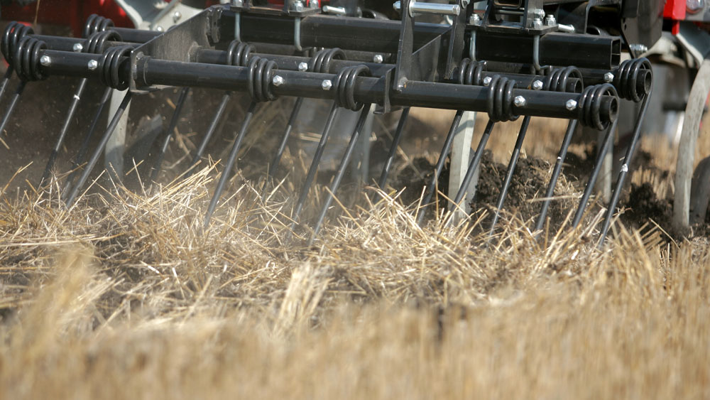Close-up of the harrow on a Wil-Rich 2500 Series Chisel Plow working the field